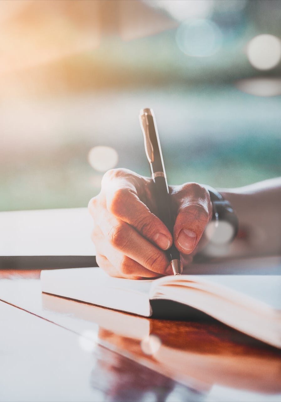 person-writing-in-a-book